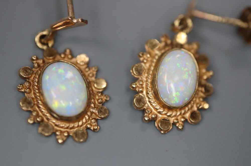 A pair of modern yellow metal and oval white opal set drop earrings, 20mm, gross 1.4 grams.